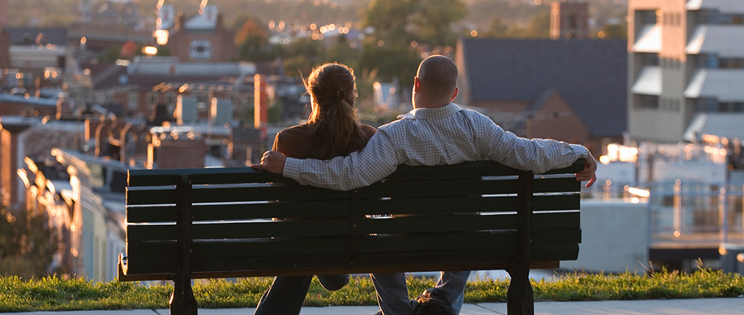 Young couple sitting on bench in park
