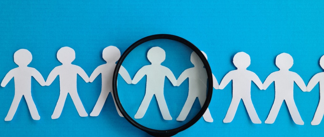 Paper cutouts of people holding hands